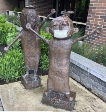 Amyas Maestas. "Amyas & Soleil" (detail with mask). 2016. Bronze. Lake Oswego, OR. Photo by Kathleen Wiens.