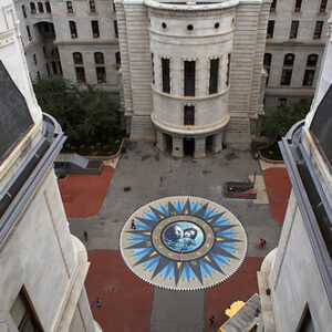 Aerial view of a courtyard with a large compass design